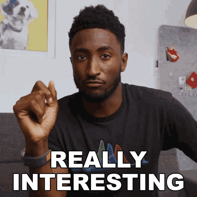 a man wearing a black shirt with the words really interesting written on it