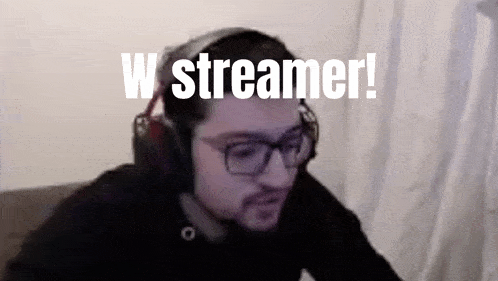 a man wearing headphones and glasses is sitting in front of a computer screen with the words w streamer written above him .