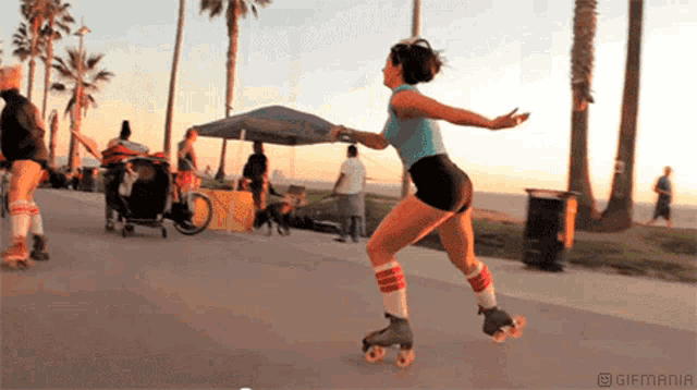 a woman rollerblading on a sidewalk with a gifmania logo on the bottom