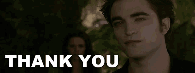 a man is standing in front of a sign that says thank you .