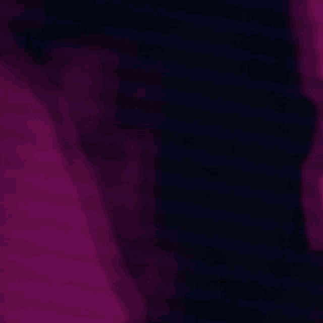 a blurry picture of a person 's face in a dark room