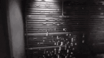 a black and white photo of a building with a shutter