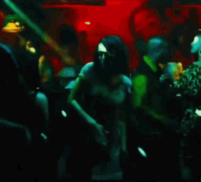 a group of people dancing in a dark room
