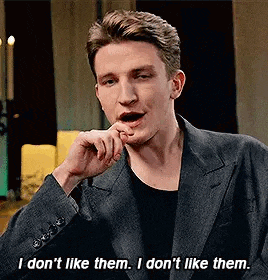 a man in a suit is talking and saying `` i don 't like them , i don 't like them .
