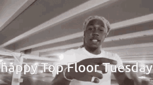 a black and white photo of a man with the words happy top floor tuesday