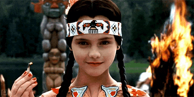 a young girl wearing a headband with a skull on it