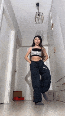 a young girl is dancing in a hallway and her pants say burton on them