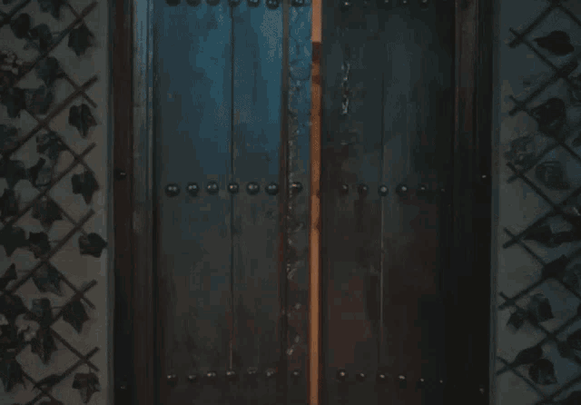 a woman in a pink dress stands in a doorway with smoke coming out of it
