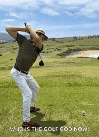 a man is swinging a golf club on a golf course with the words `` who is the golf god now '' .
