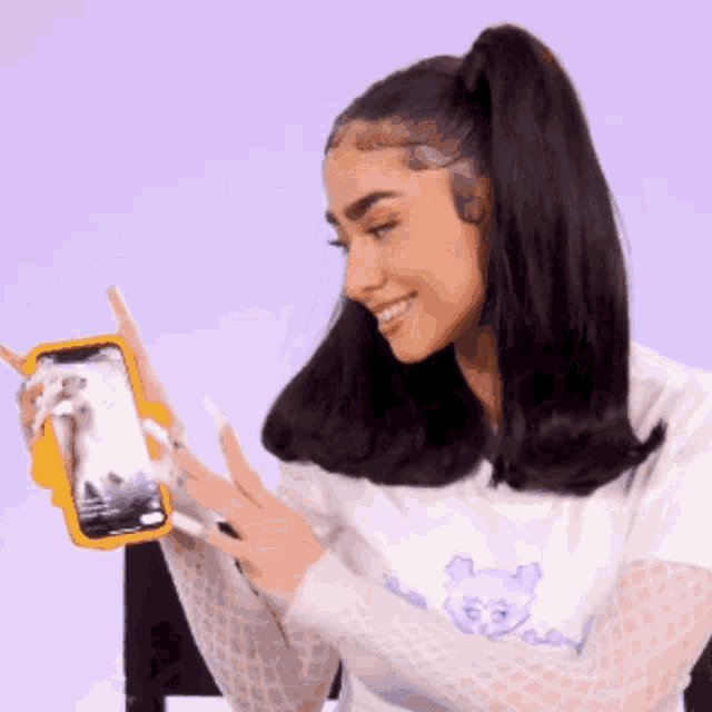 a woman is taking a picture of herself with a cell phone