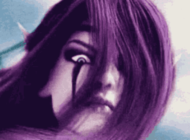 a close up of a woman 's face with a tear coming out of her eye