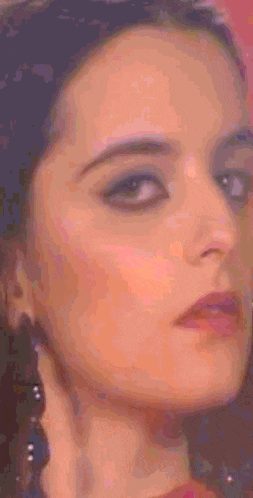 a close up of a woman 's face with a pink background