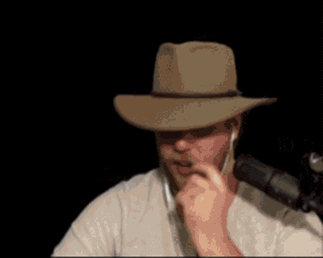a blurry picture of a man wearing a hat and holding a microphone