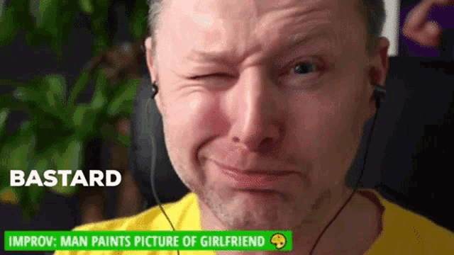a man wearing headphones is making a funny face with the word bastard on the bottom