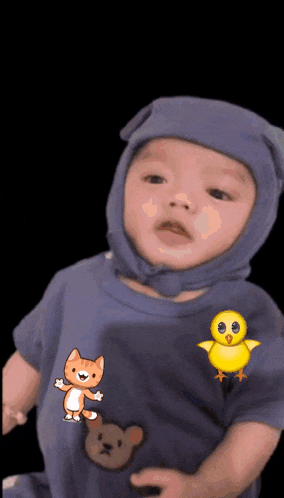 a baby wearing a blue shirt with a cat and bear on it