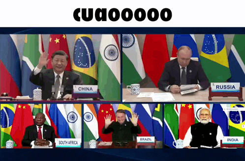 a group of men are sitting at a table with flags behind them and a sign that says china on it