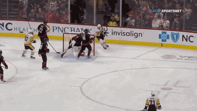 a hockey game is being played in front of a pnc bank banner