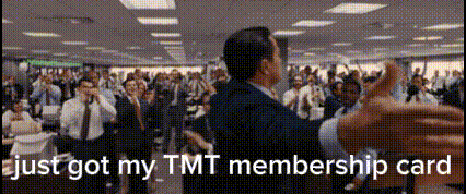 a man in a suit is dancing in front of a crowd with the words just got my tmt membership card
