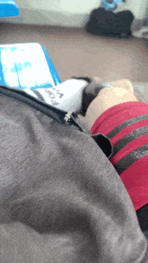a person laying on a chair with a zipper in their pocket that says ' a ' on it