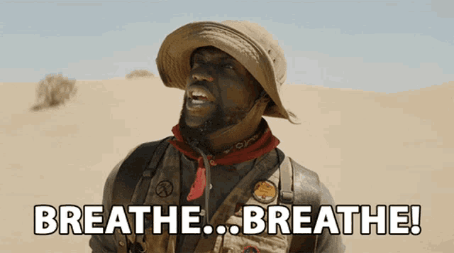 a man in a cowboy hat says breathe in the desert