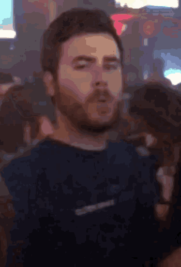 a man with a beard is wearing a shirt with the word converse on it