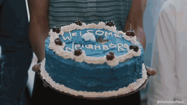 a blue cake that says welcome neighbors on it