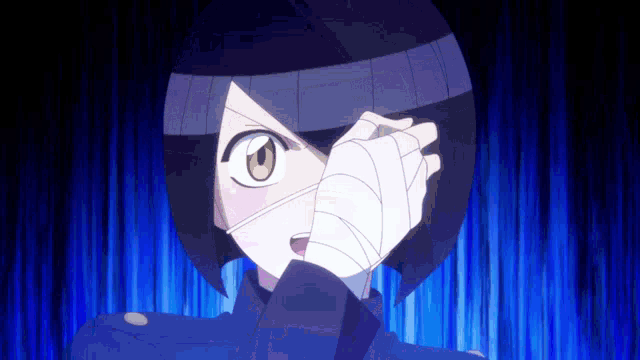 a person with a bandage on their hand is covering their face