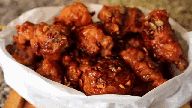 a bowl of fried chicken covered in sauce