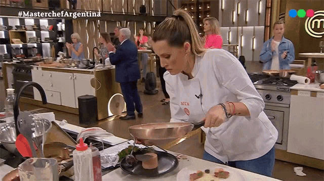 a woman is cooking in a kitchen with the hashtag #masterchefargentina on the bottom right