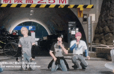 a group of people are kneeling down in front of a sign that says groove just wanna know climax
