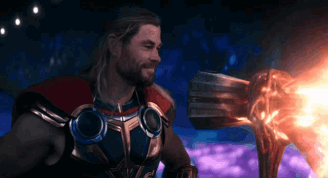 a man in a superhero costume is smiling and holding a sword