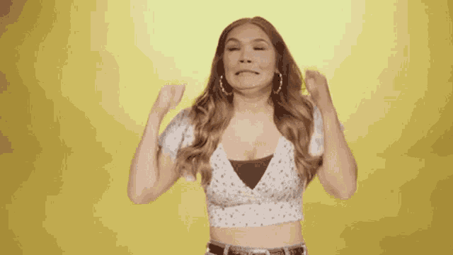 a woman in a white dress is making a funny face .