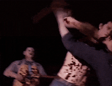 a man with blood on his torso is being attacked