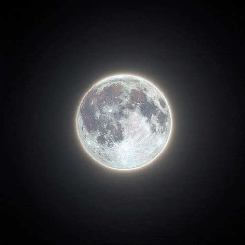 a full moon in a dark sky with a glowing edge