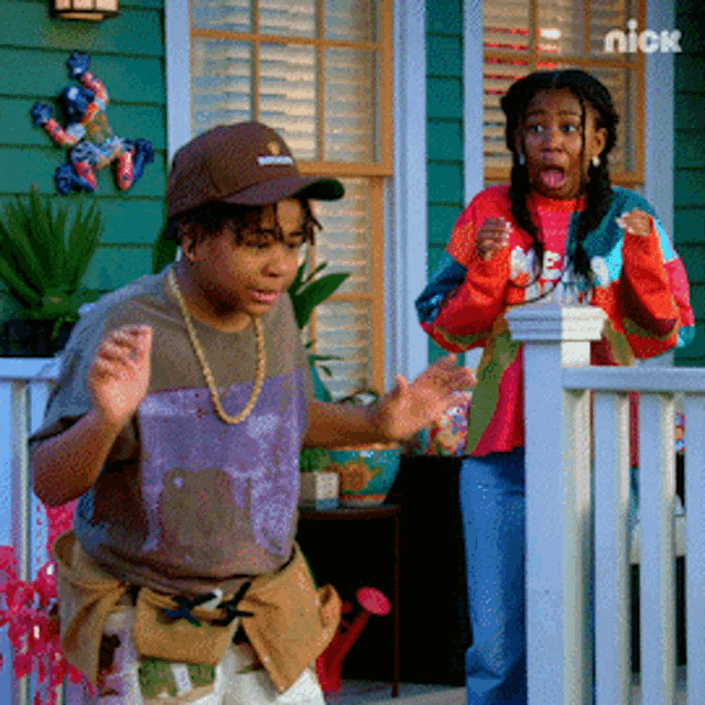 a boy and a girl are standing on a porch in front of a green house with a nick logo in the corner