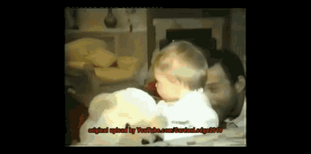 a video of a man holding a baby was originally uploaded to youtube