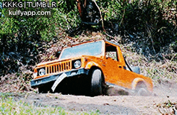 an orange jeep is driving down a dirt road with the website kulfvapp.com on the bottom