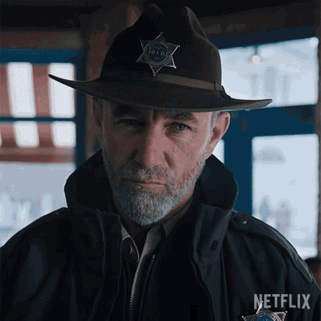 a man in a sheriff 's hat with a badge that says sheriff