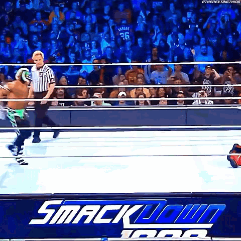 a wrestling match is taking place in front of a crowd at a smack down event