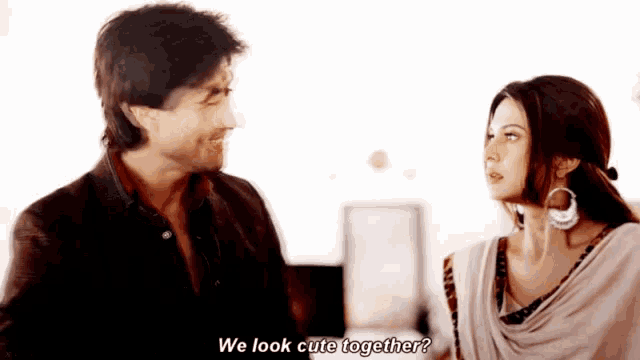 a man and a woman are looking at each other and the woman is asking if they look cute together
