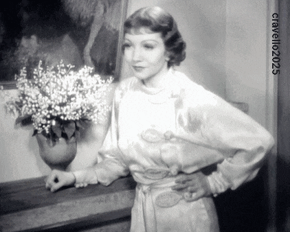 a woman in a white dress stands in front of a vase of white flowers with the year 2025 on the bottom