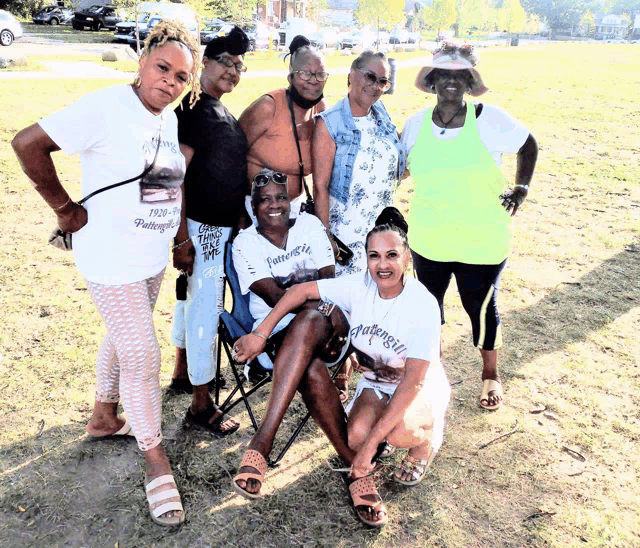 a group of women are posing for a picture and one of them is wearing a shirt that says " faithfulness "