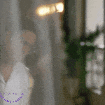 a gif of a woman behind a curtain that says ' one happy insaan ' on the bottom