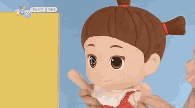 a person is holding a doll 's head in front of a cell phone