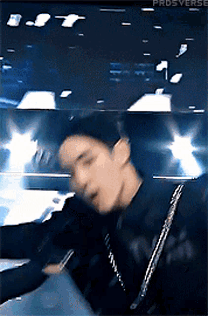 a blurry picture of a man in a black jacket with the words prdsverse on the bottom right