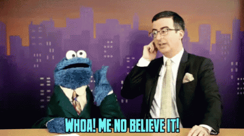 a man in a suit talks on a cell phone next to a cookie monster who says whoa! me no believe it