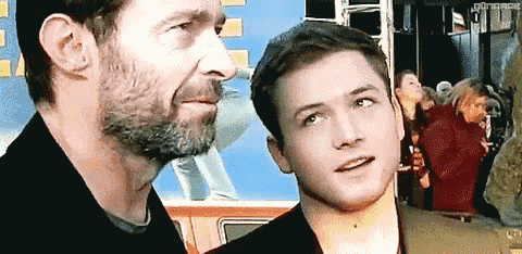 a man with a beard and a young man with a beard are standing next to each other .