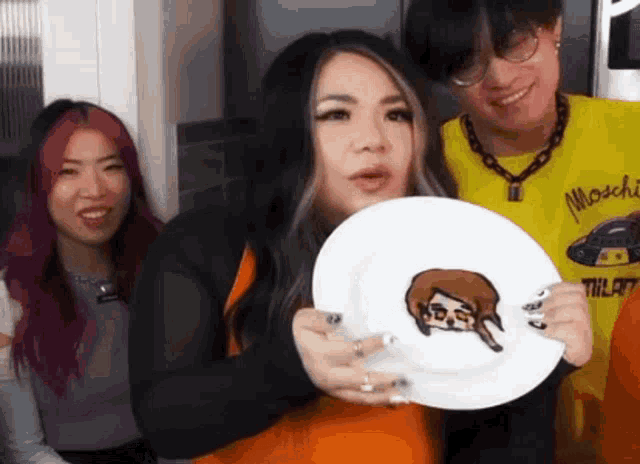 a woman is holding a white plate with a drawing of a man on it .