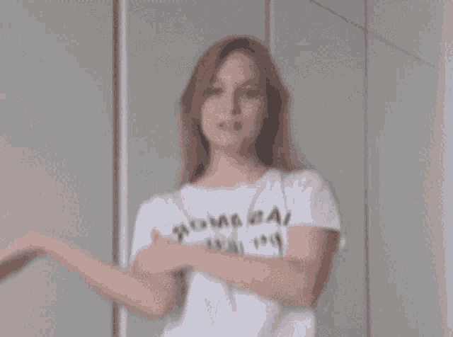 a woman wearing a white t-shirt that says ' i 'm sorry ' on it