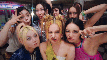 a group of girls are posing for a picture in front of a sign that says ' arcade '